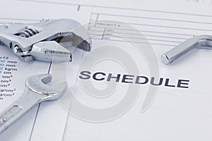 Engineering schedule documents with wrench. Maintencance concept