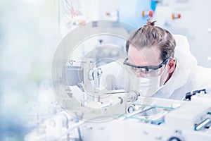 Engineering scientist working with advanced technology medical device in science laboratory for experimental research