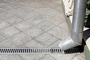 Engineering structure a downspout with a drainage grate.