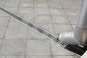 Engineering structure a downspout with a drainage grate.