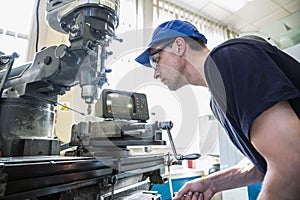 Engineering student using large drill