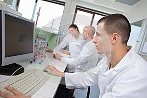 Engineering students in lab using computer