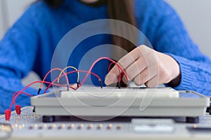 Engineering students working in the lab. Students are adjusting an electrical`s components inside lab