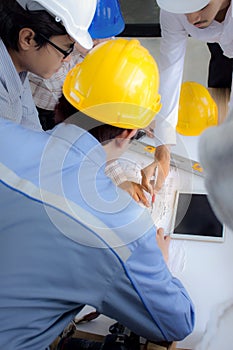 Engineering team is meeting, planning construction work at construction site/Selective focus