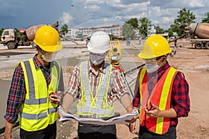 The engineering team reads the construction blueprints