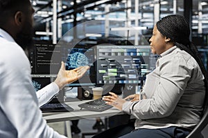 Engineering team working together in data center running AI tools