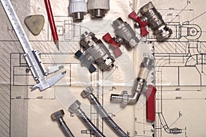 Engineering tools and plumbing details on a technical drawing. Caliper and ruler