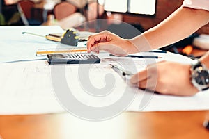 Engineering using calculator for accounting and analyzing building structure from blueprint