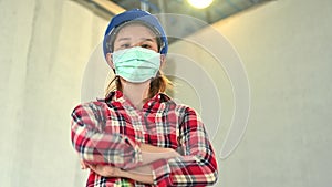 Engineering woman wearing face mask at construction site. New normal and social distancing