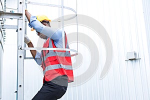 Engineering or worker descended the fire escape to the safe zone. Man in Fire escape to the roof. Worker climbing down fire escape