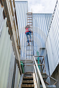 Engineering or worker descended the fire escape to the safe zone. Man in Fire escape to the roof. Worker climbing down fire escape