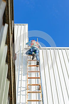 Engineering or worker descended the fire escape to the safe zone. Man in Fire escape to the roof. Worker climbing down fire escape