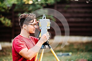 engineering working with equipment and theodolite, total station at a construction site