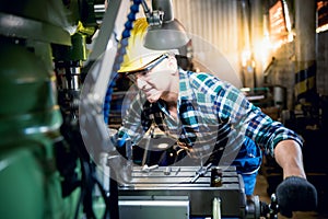 Engineers Caucasian man are working by controlling steel lathes