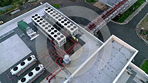 Engineers check industrial ventilation air conditioning system - Drone footage