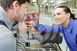 Engineers checking dials on machinery