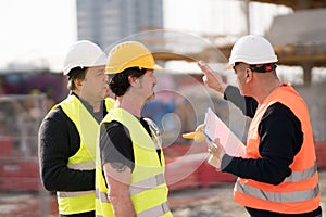 Engineers and construction workers at work photo