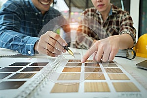 Engineers, designers and interior designers are finalizing the design of interiors by discussing selecting materials and photo