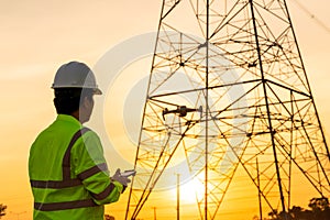 Engineers or Electrician use drone to fly inspections at the electric power station to view the planning work by producing
