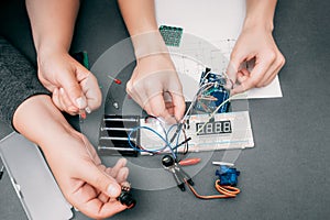 Engineers hands connecting electronic components