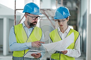 Engineers in hardhats have conversation