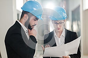 Engineers in hardhats have conversation