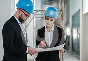 Engineers in hardhats have conversation