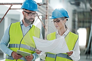 Engineers in hardhats have conversation