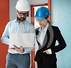 Engineers in hardhats have conversation