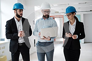 Engineers in hardhats have conversation