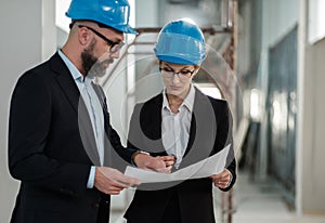 Engineers in hardhats have conversation