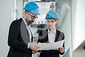 Engineers in hardhats have conversation