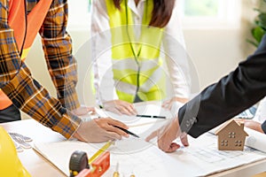 Engineers or inspector holding blueprint of construction on site. Contractor inspection drawing before start project civil.