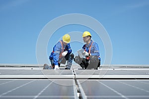 Engineers install solar cells on the roof of factory