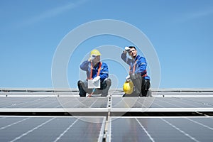 Engineers install solar cells on the roof of factory