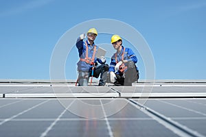 Engineers install solar cells on the roof of factory