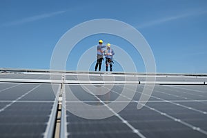 Engineers install solar cells on the roof of factory