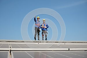 Engineers install solar cells on the roof of factory