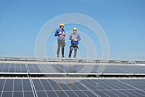 Engineers install solar cells on the roof of factory