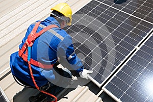 Engineers install solar cells on the roof of factory