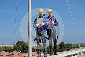 Engineers install solar cells on the roof of factory