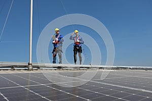 Engineers install solar cells on the roof of factory