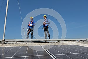 Engineers install solar cells on the roof of factory