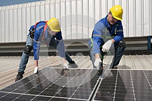 Engineers install solar cells on the roof of factory