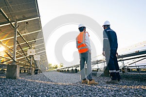 Engineers with investor walk to check the operation of the solar farmsolar panel systems, Alternative energy to conserve the