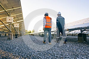 Engineers with investor walk to check the operation of the solar farmsolar panel systems, Alternative energy to conserve the