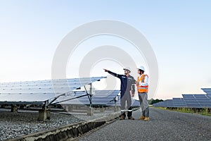 Engineers with investor walk to check the operation of the solar farmsolar panel systems, Alternative energy to conserve the