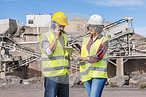 Engineers with modern gadgets working on construction site photo