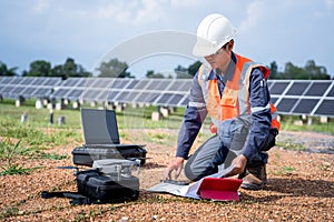 Engineers preparing drones to fly, inspecting the solar cells at high angles to thermo scan the solar panel for potential