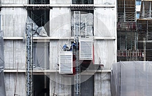 Engineers repairing elevators at construction site